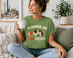 A woman wearing a leaf Low Energy Cat cute animal graphic t-shirt drinking coffee.