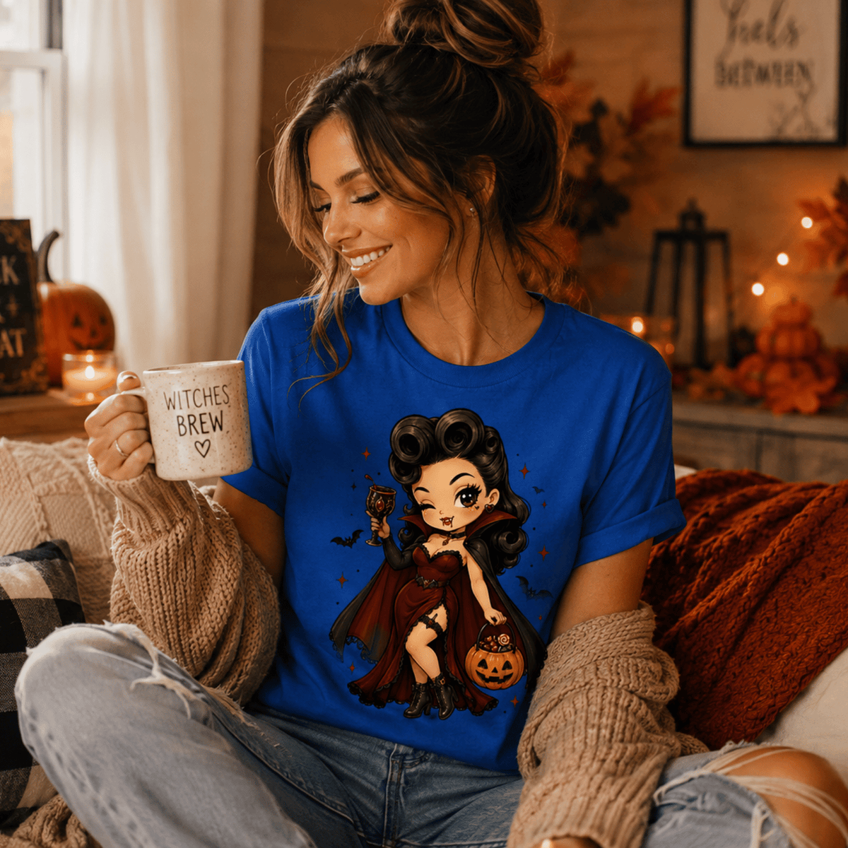 A woman wearing a true royal Vampire Vanessa halloween pinup graphic t-shirt drinking coffee.