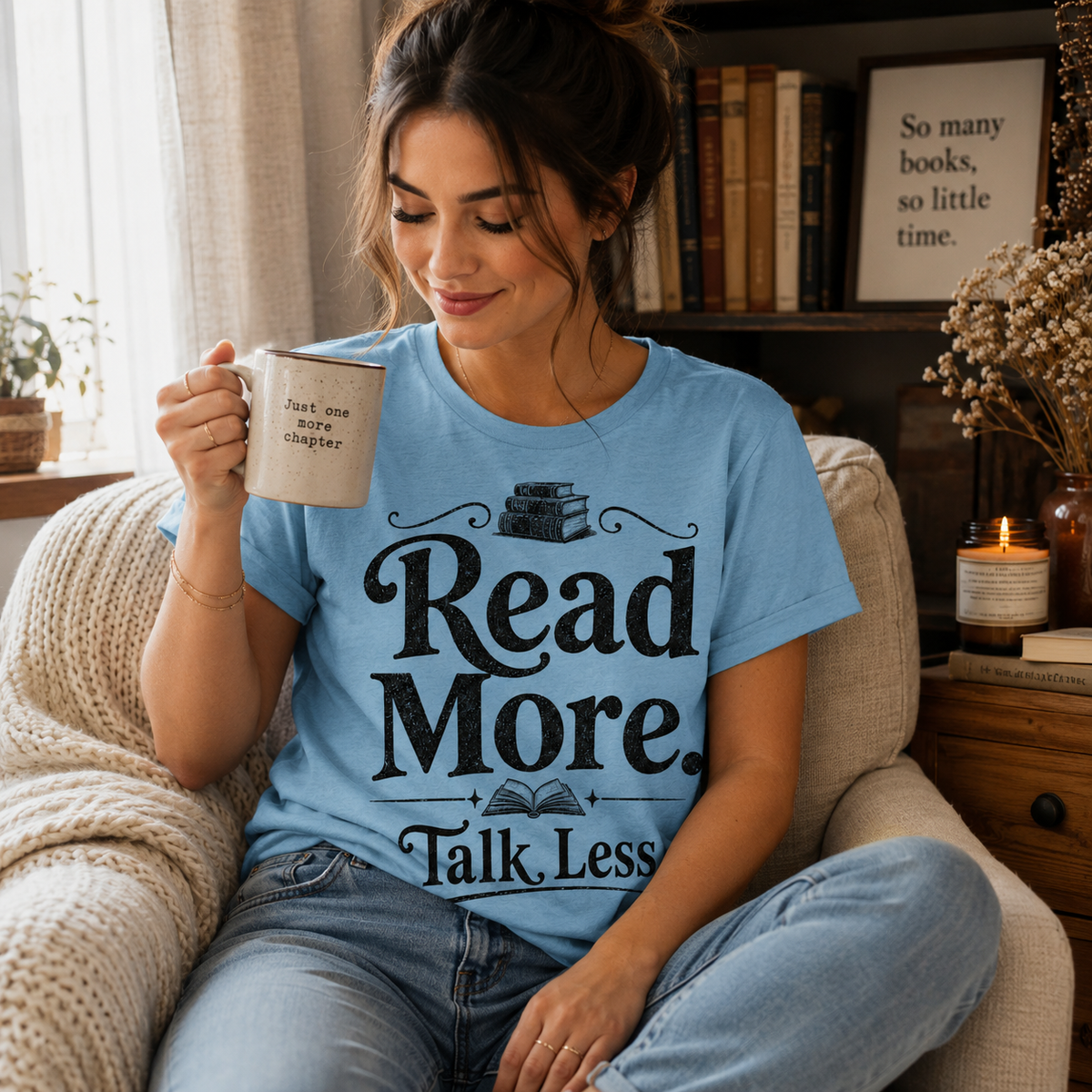 A woman wearing a baby blue Talk Less funny book graphic t-shirt drinking coffee.