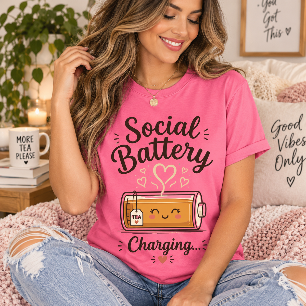 A woman wearing a charity pink Social Battery Tea cute tea graphic t-shirt.