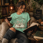 A woman wearing a mint Nonfictiony whimsical book graphic t-shirt reading a book.