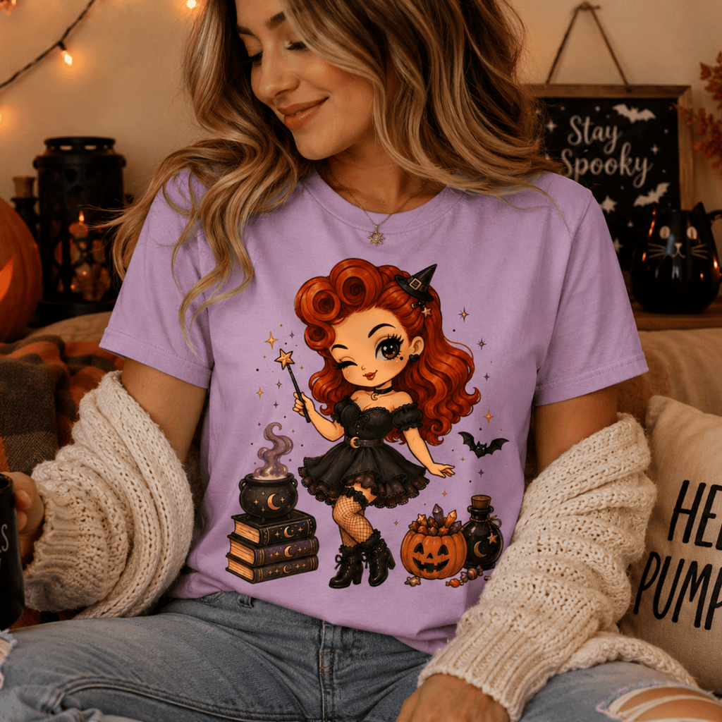 A woman wearing a lilac Witchy Wendy halloween pinup graphic t-shirt relaxing in a living room.