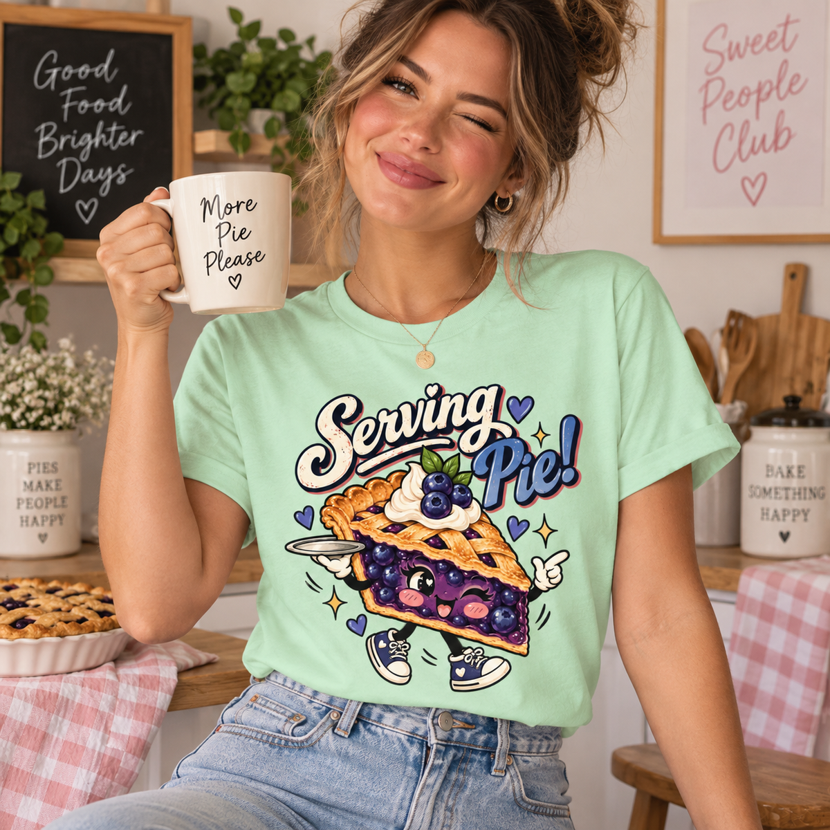 A woman wearing a mint Serving Pie retro food graphic t-shirt.