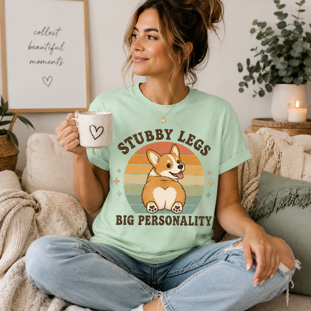 A woman wearing a mint Stubby Legs cute animal graphic t-shirt drinking coffee.