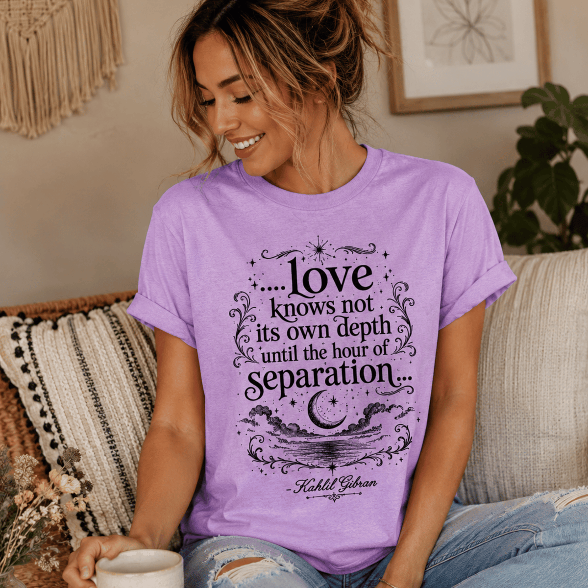 A woman wearing a lilac Love Knows Not book quote graphic t-shirt.