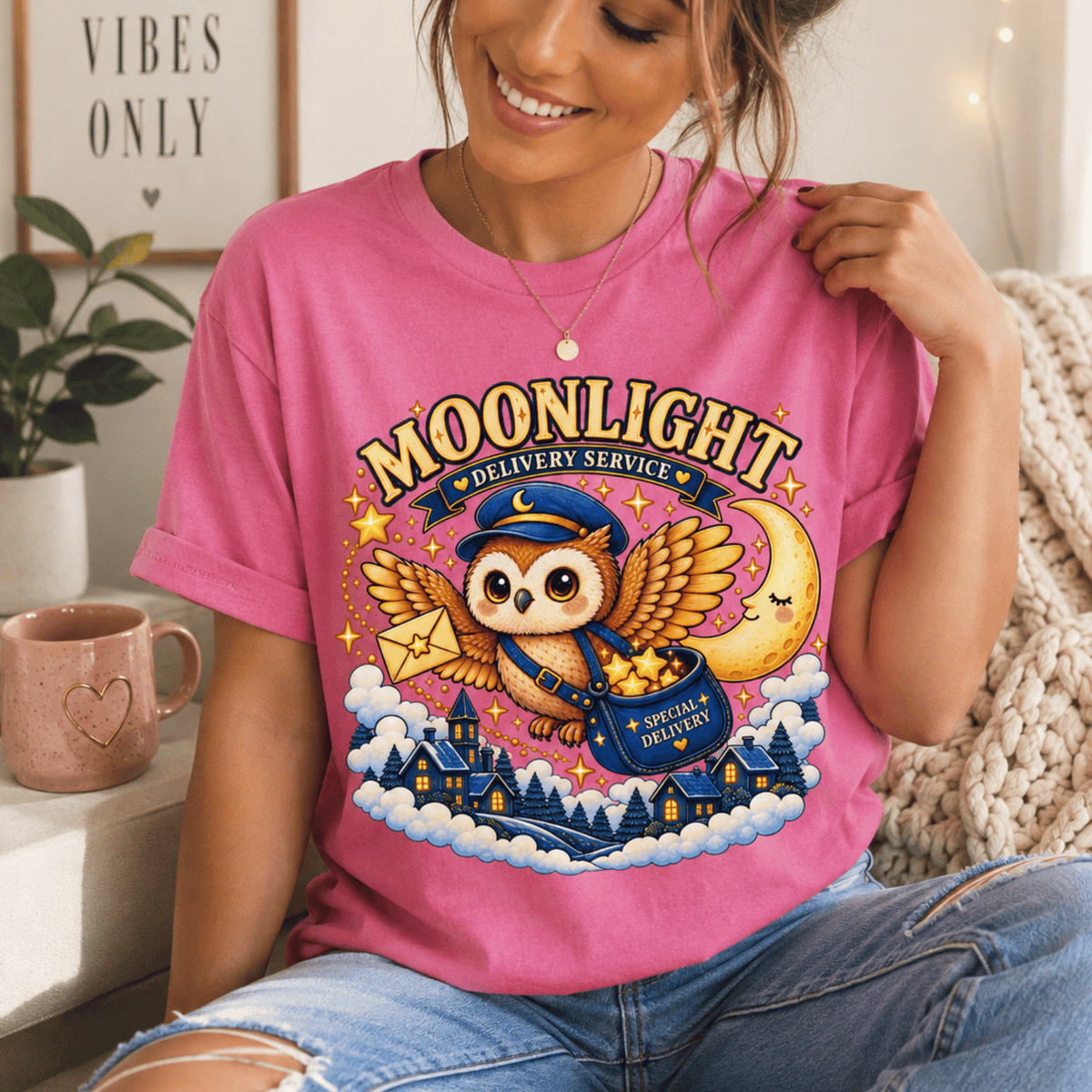 Moonlight Delivery cute animal graphic t-shirt cozy flat lay in charity pink.