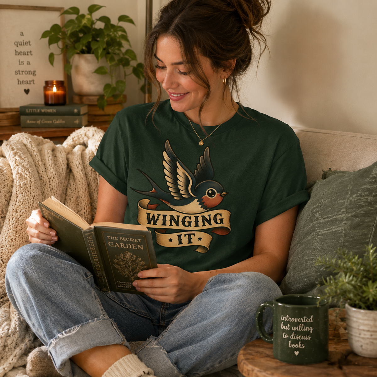 A woman wearing an evergreen Winging It cute animal graphic t-shirt drinking coffee.