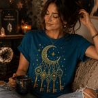A woman wearing a deep teal Cosmic Keyring celestial graphic t-shirt.