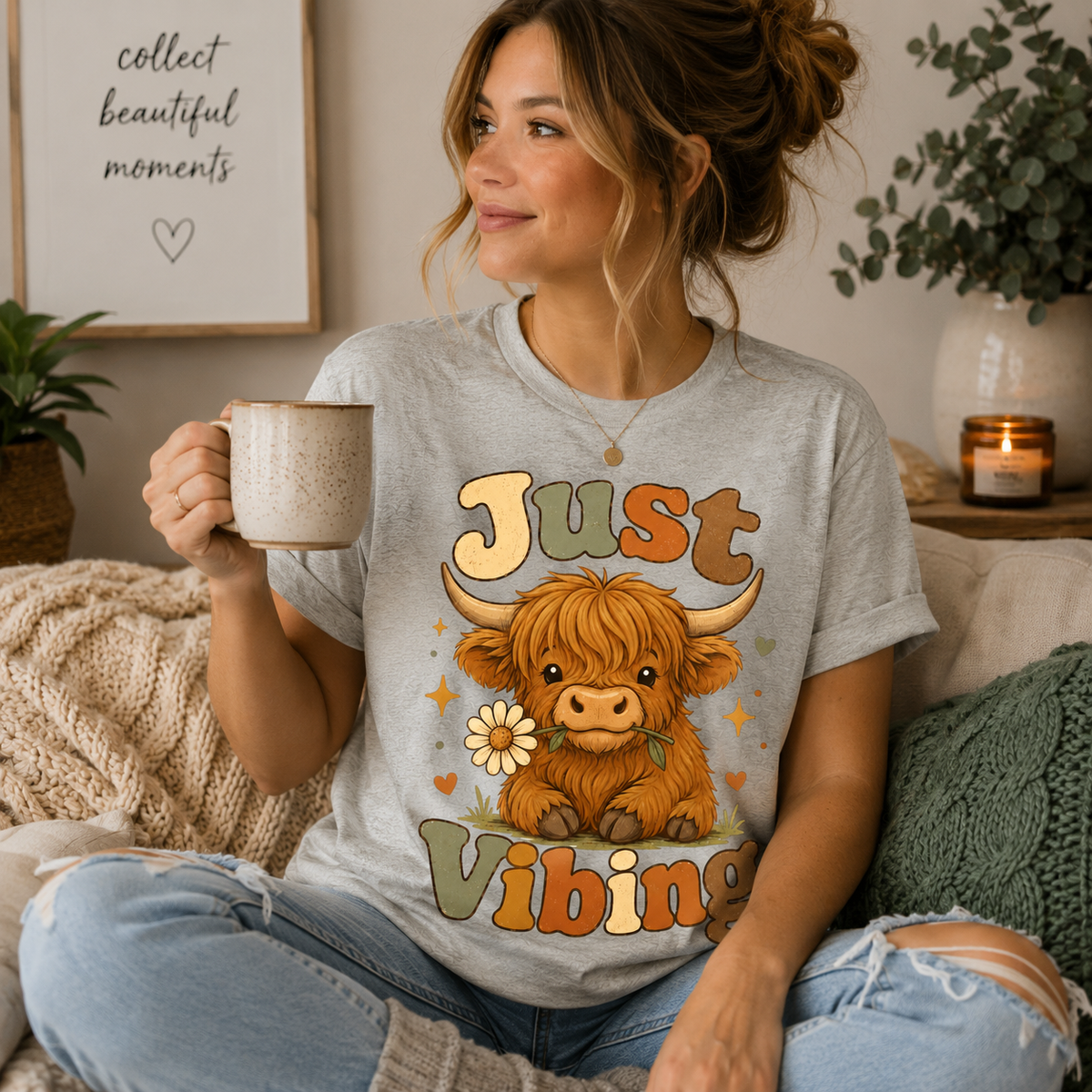 A woman wearing an athletic heather Just Vibing Cow cute animal graphic t-shirt drinking coffee.