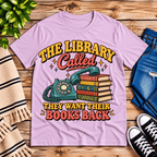 The Library Called book lovers graphic t-shirt cozy flat lay in lilac.