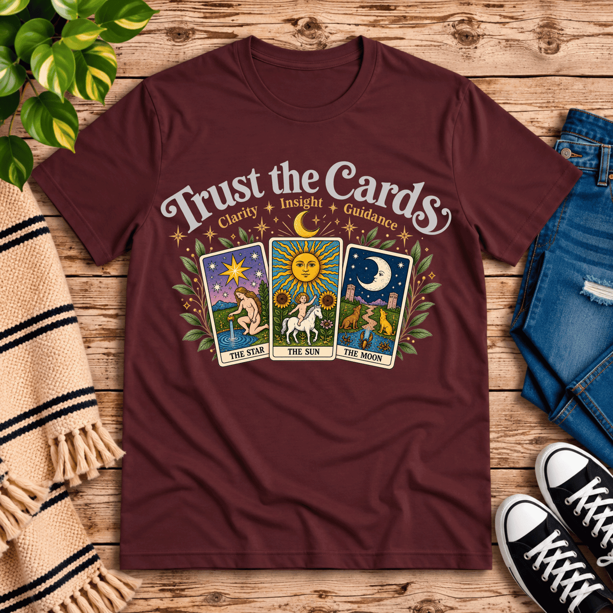 Trust the Cards mystical tarot graphic t-shirt cozy flat lay in maroon.