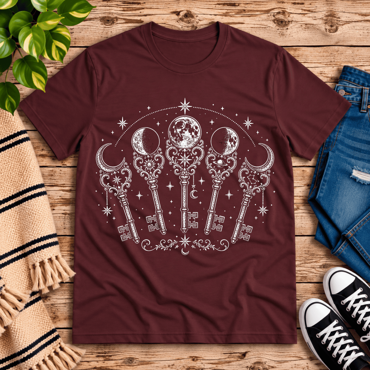 Moon Phase Keys celestial graphic t-shirt cozy flat lay in maroon.