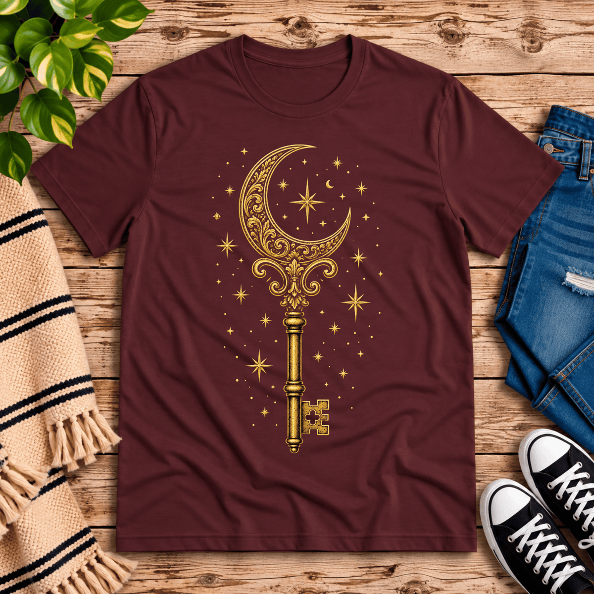 Moonlight Key whimsical celestial graphic t-shirt cozy flat lay in maroon.