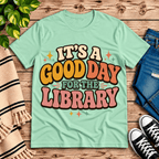 It's A Good Day book lovers graphic t-shirt cozy flat lay in mint.