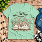 Nonfictiony whimsical book graphic t-shirt cozy flat lay in mint.