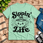 Sippin' on Life cute coffee graphic t-shirt cozy flat lay in mint.