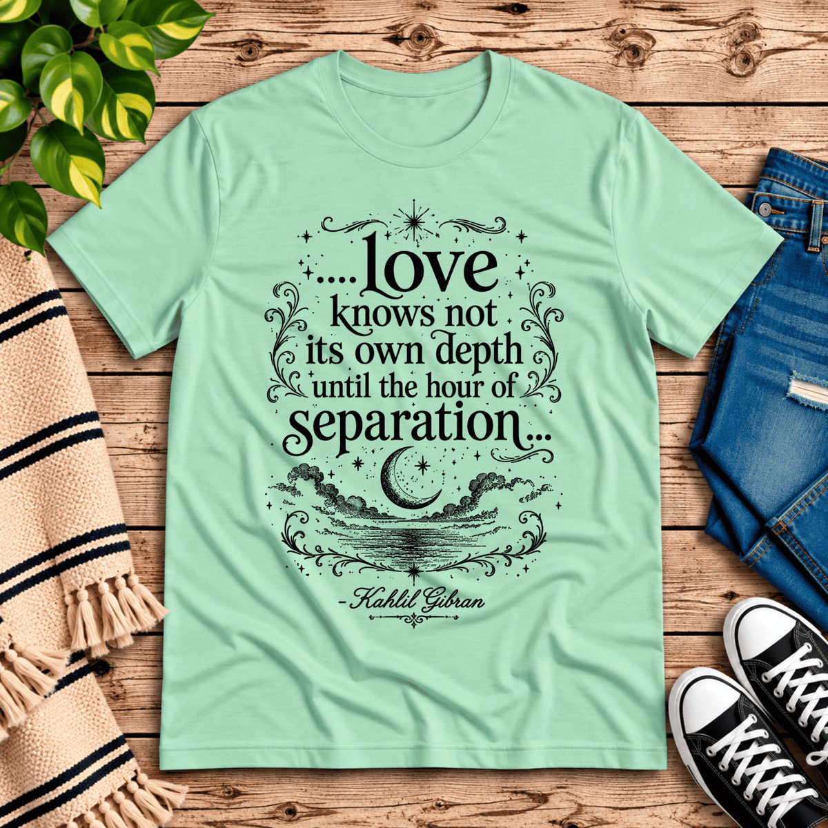 Love Knows Not book quote graphic t-shirt cozy flat lay in mint.