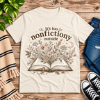 Nonfictiony whimsical book graphic t-shirt cozy flat lay in natural.