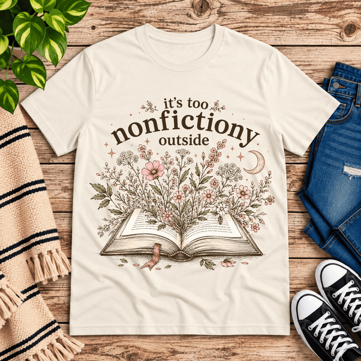 Nonfictiony whimsical book graphic t-shirt cozy flat lay in natural.