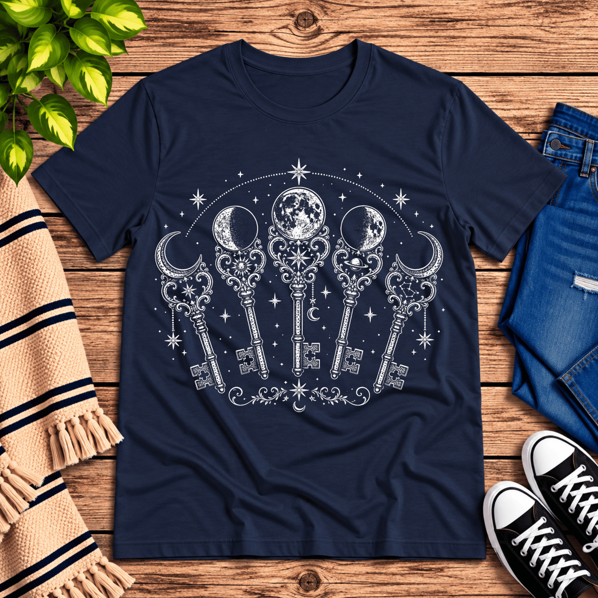 Moon Phase Keys celestial graphic t-shirt cozy flat lay in navy.