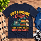 The Library Called book lovers graphic t-shirt cozy flat lay in navy.