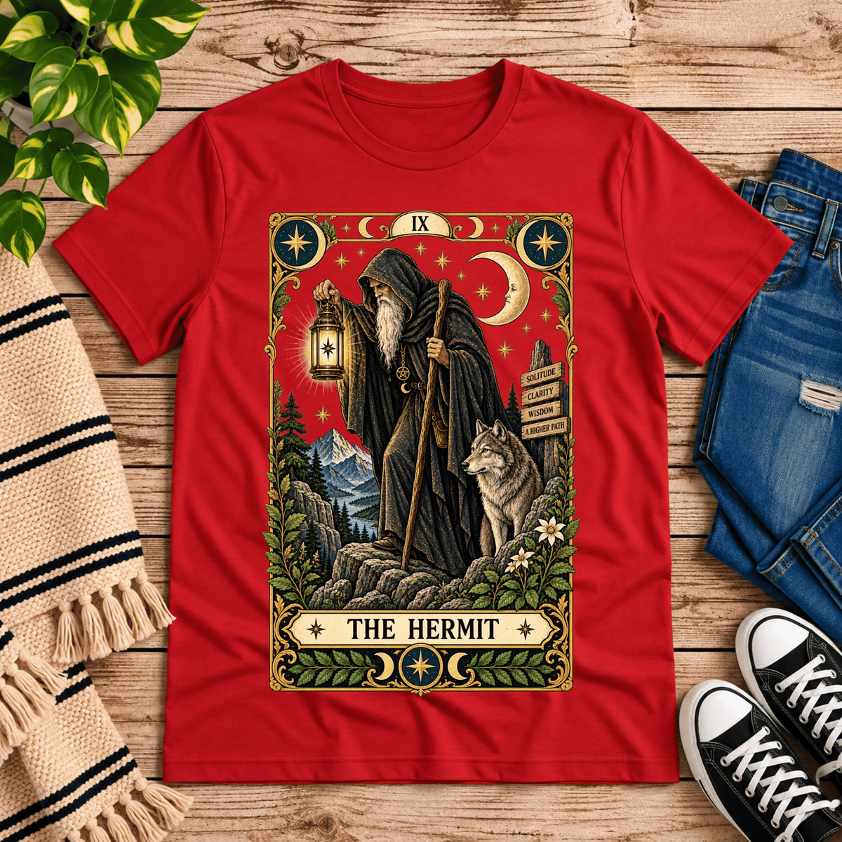 The Hermit tarot card graphic t-shirt cozy flat lay in red.