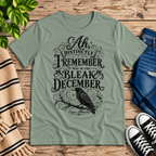 Bleak December book quote graphic t-shirt cozy flat lay in sage.