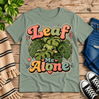 Leaf Me Alone funny nature graphic t-shirt cozy flat lay in sage.