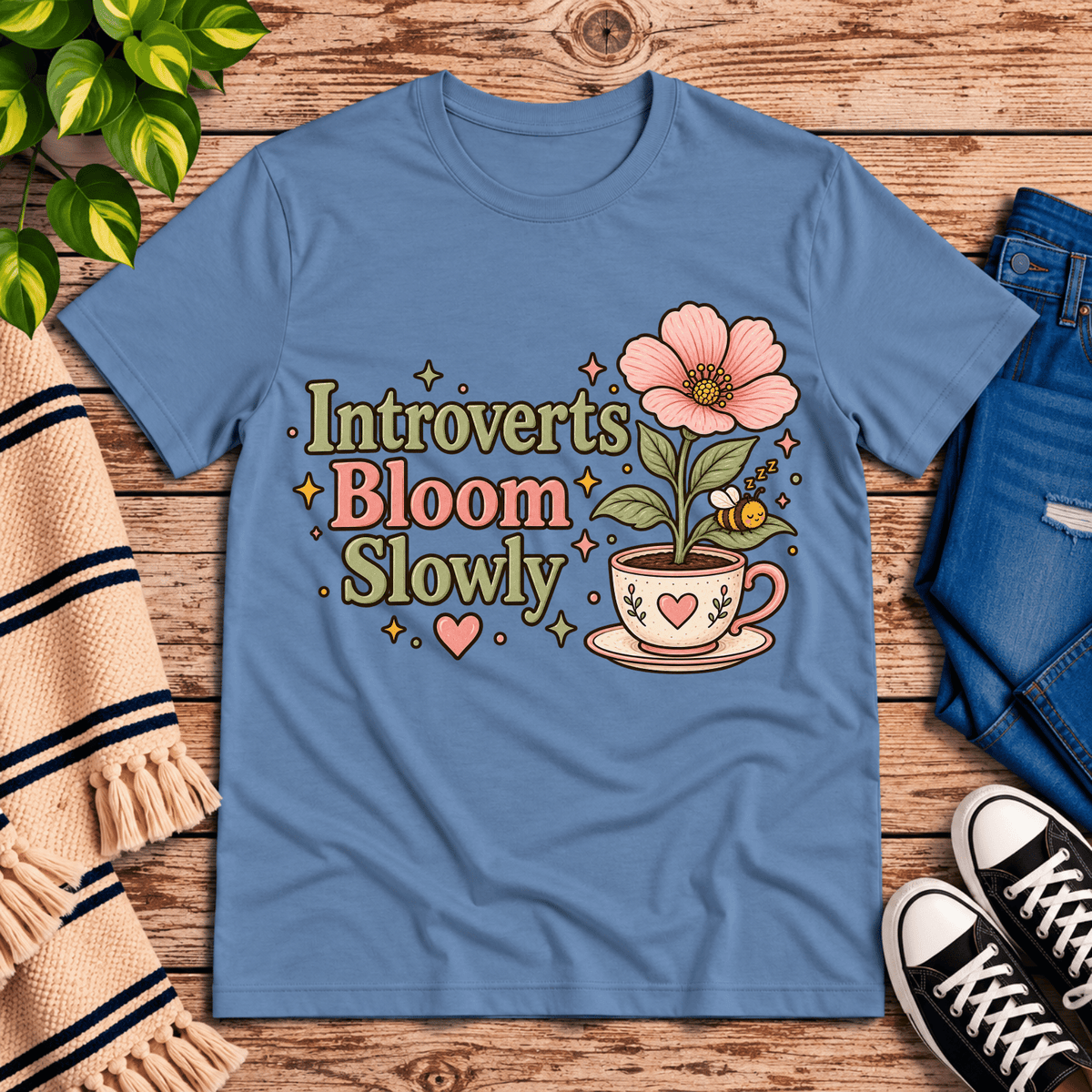 Introverts Bloom Slowly cute plant graphic t-shirt cozy flat lay in steel blue.