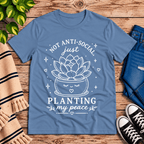 Planting My Peace cute plant graphic t-shirt cozy flat lay in steel blue.
