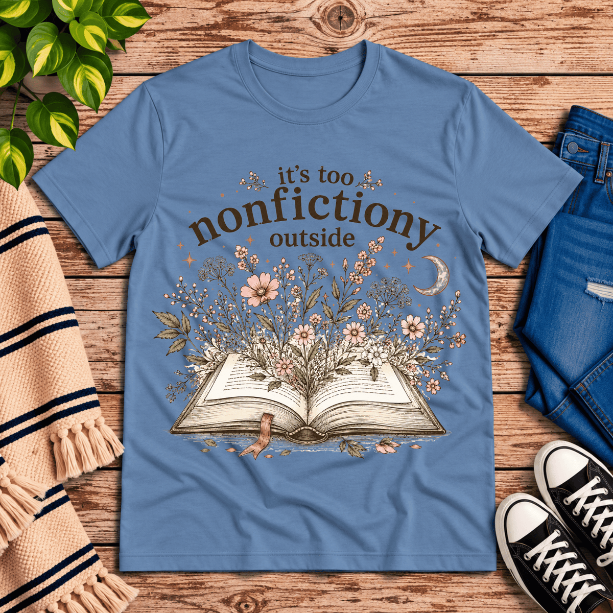 Nonfictiony whimsical book graphic t-shirt cozy flat lay in steel blue.
