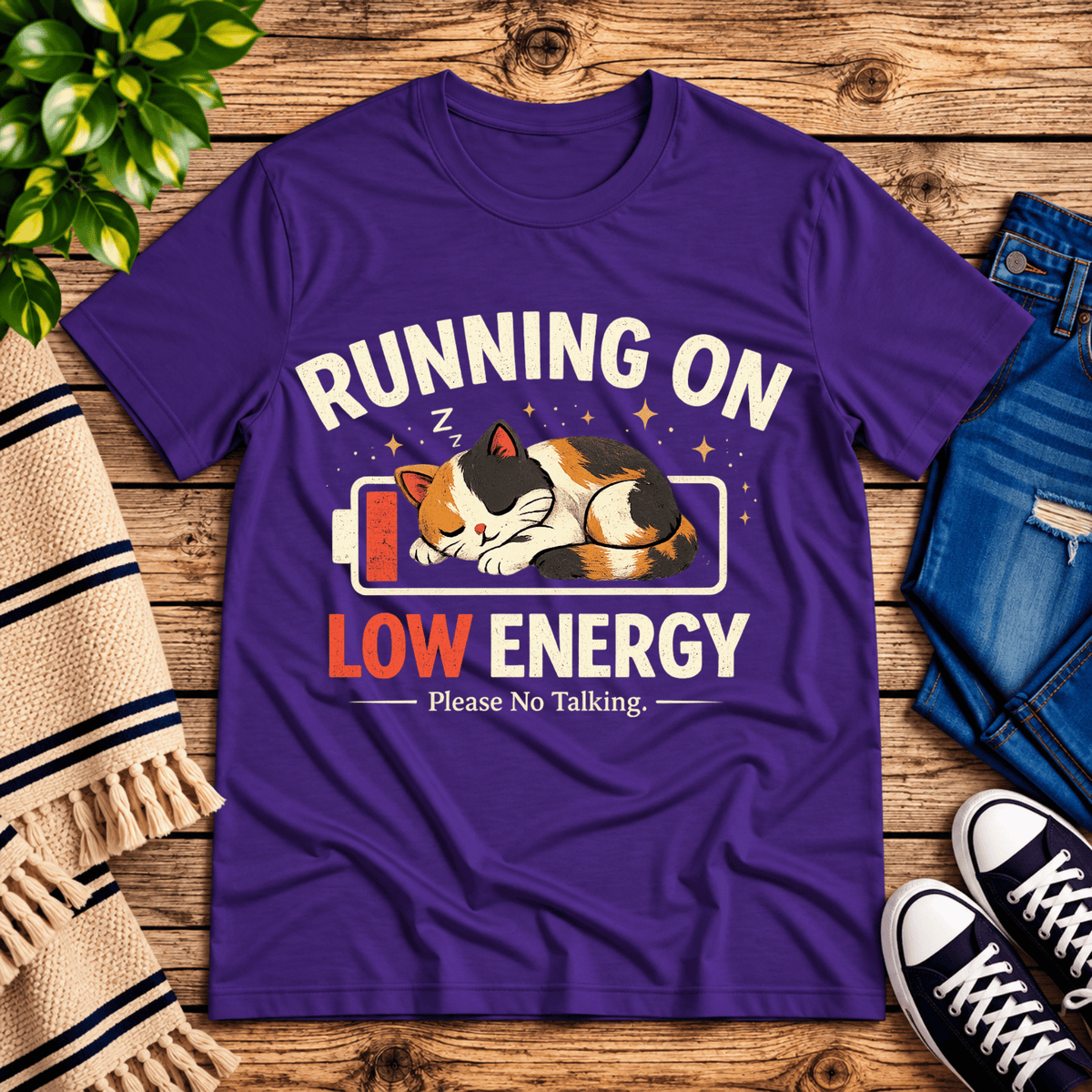 Low Energy Cat cute animal graphic t-shirt cozy flat lay in team purple.