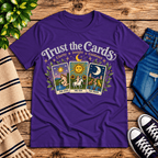 Trust the Cards mystical tarot graphic t-shirt cozy flat lay in team purple.