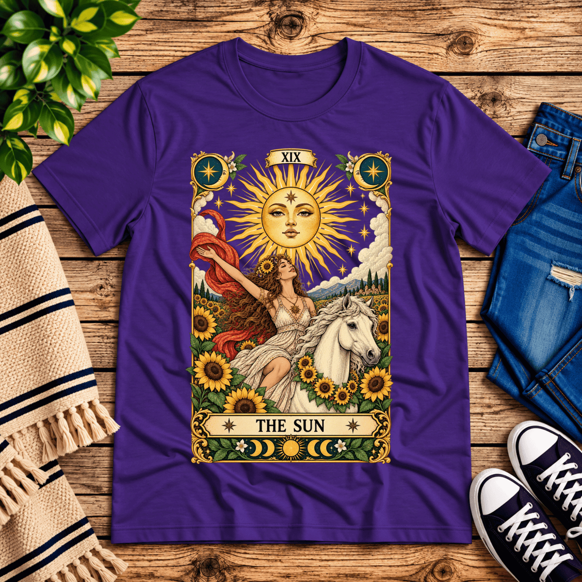 The Sun tarot card mystical graphic t-shirt cozy flat lay in team purple.