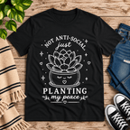 Planting My Peace cute plant graphic t-shirt cozy flat lay in vintage black.