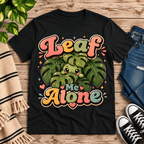 Leaf Me Alone funny nature graphic t-shirt cozy flat lay in vintage black.
