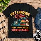 The Library Called book lovers graphic t-shirt cozy flat lay in vintage black.