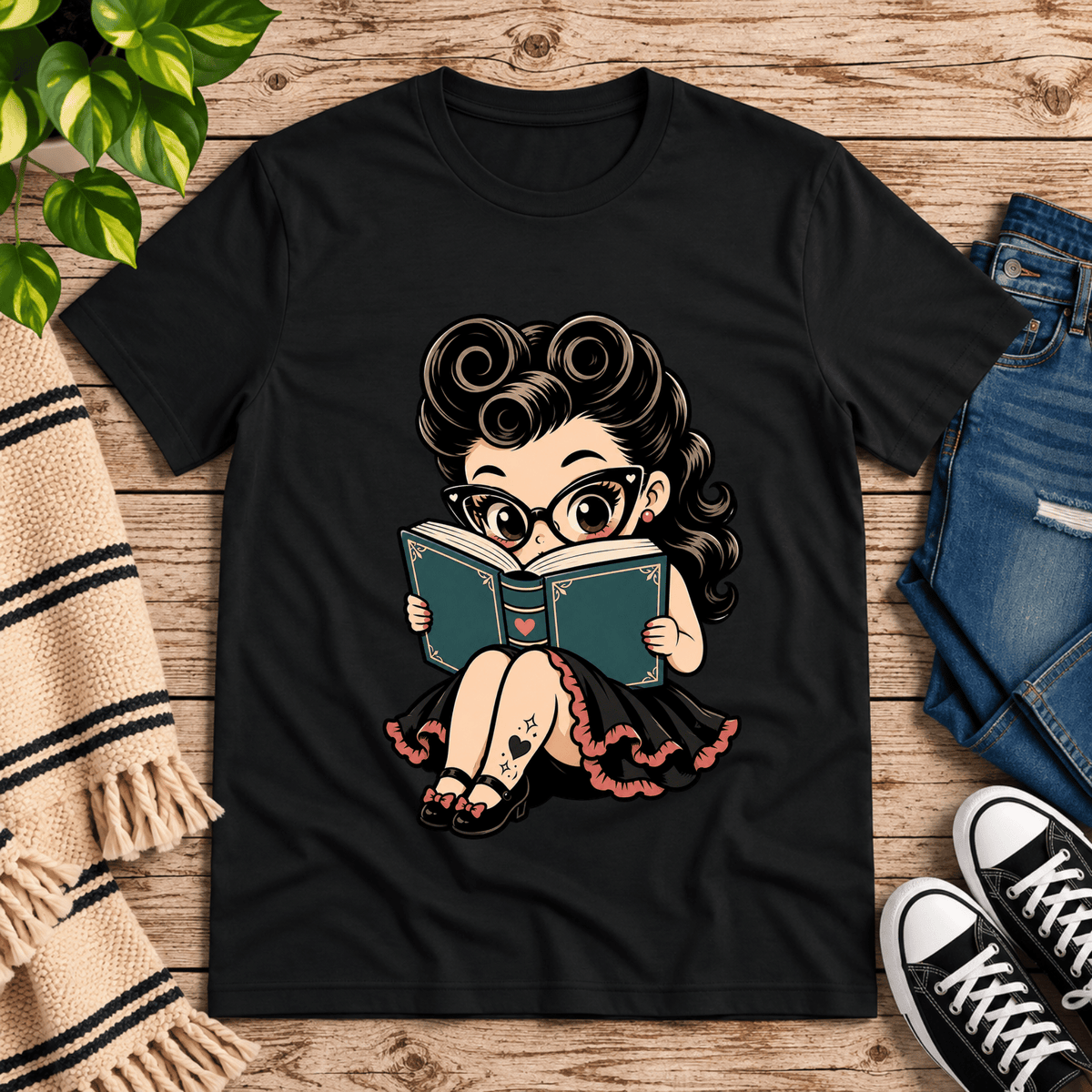 Bookworm Betty pinup graphic t-shirt cozy flat lay in vintage black.