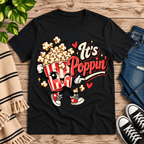 It's Poppin' cute food graphic t-shirt cozy flat lay in vintage black.