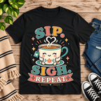 Sip. Sigh. Repeat. coffee graphic t-shirt cozy flat lay in vintage black.