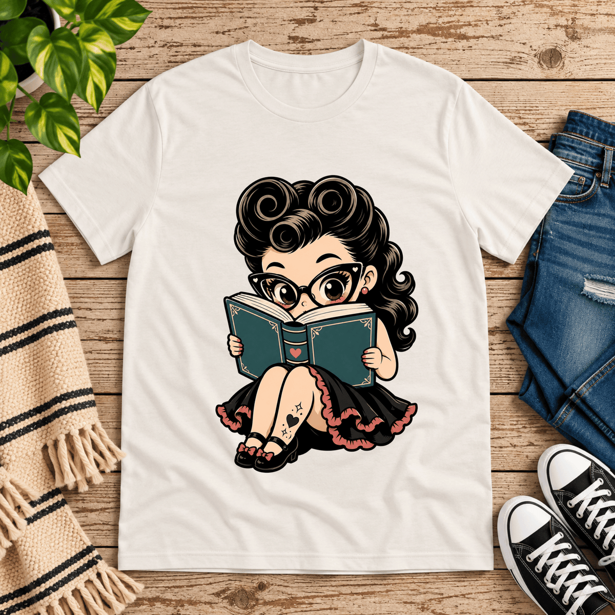 Bookworm Betty pinup graphic t-shirt cozy flat lay in vintage white.