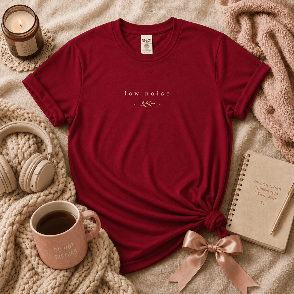 Low Noise introvert graphic t-shirt cozy flat lay in antique cherry red.