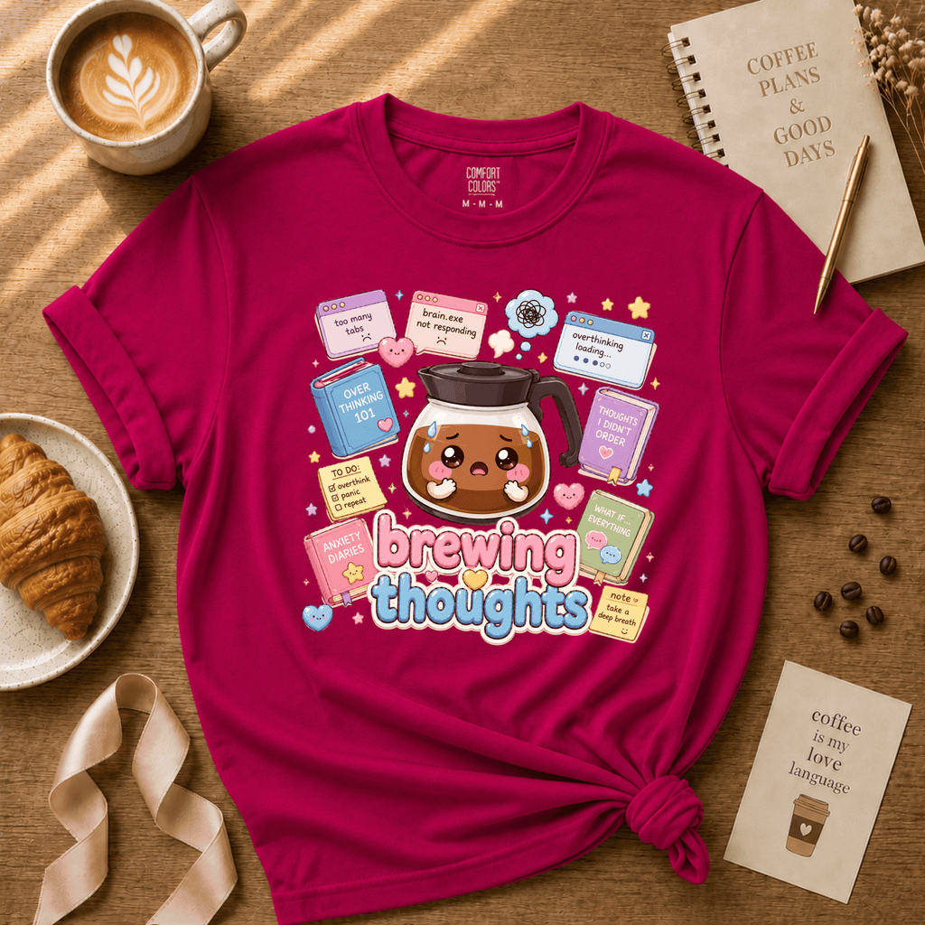 Brewing Thoughts coffee lovers graphic t-shirt cozy flat lay in antique heliconia.