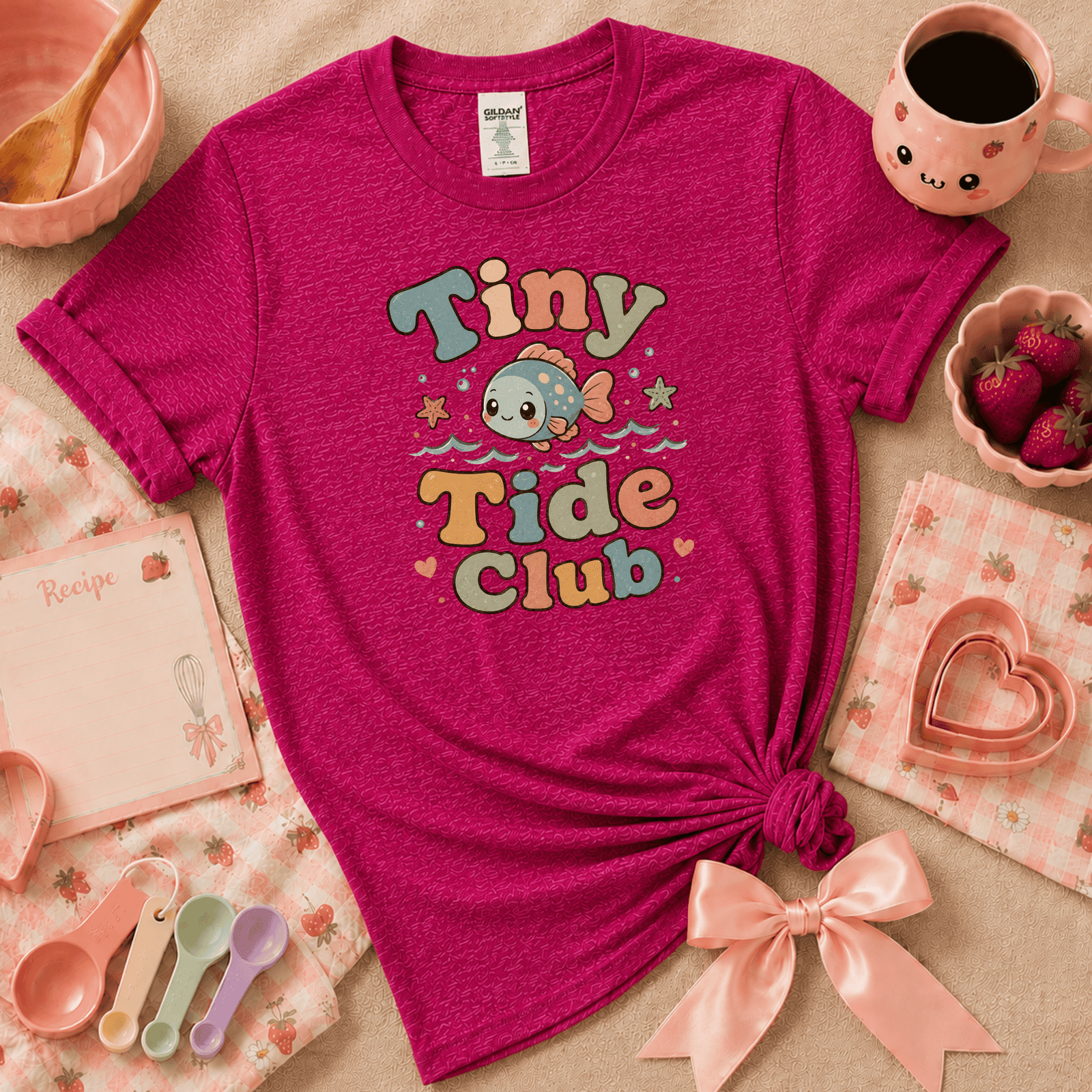 Tiny Tide Club cute animal graphic t-shirt displayed in a cozy flat lay in antique heliconia.