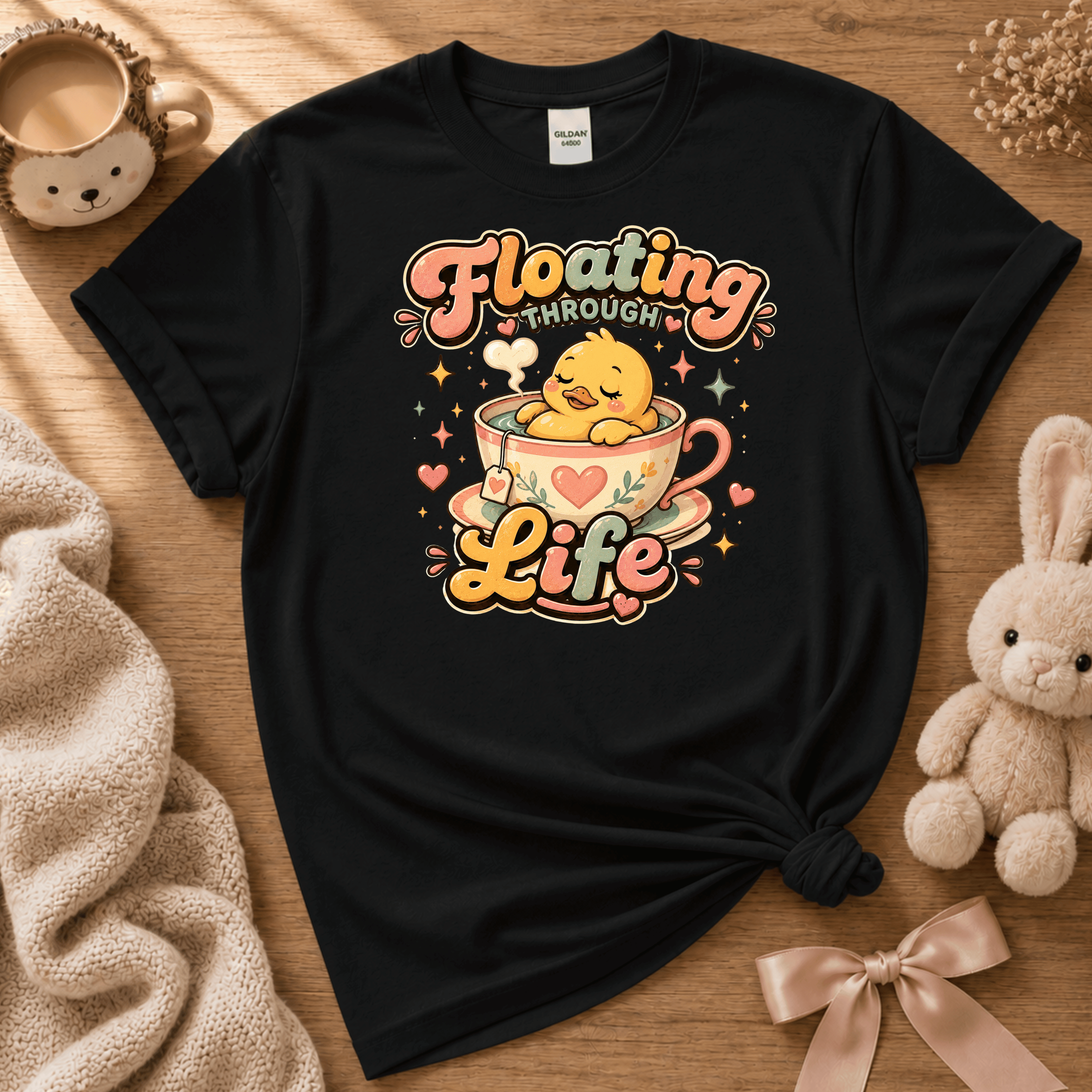Floating Through Life cute animal graphic t-shirt cozy flat lay in black.