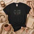 Too Much introvert graphic t-shirt cozy flat lay in black.