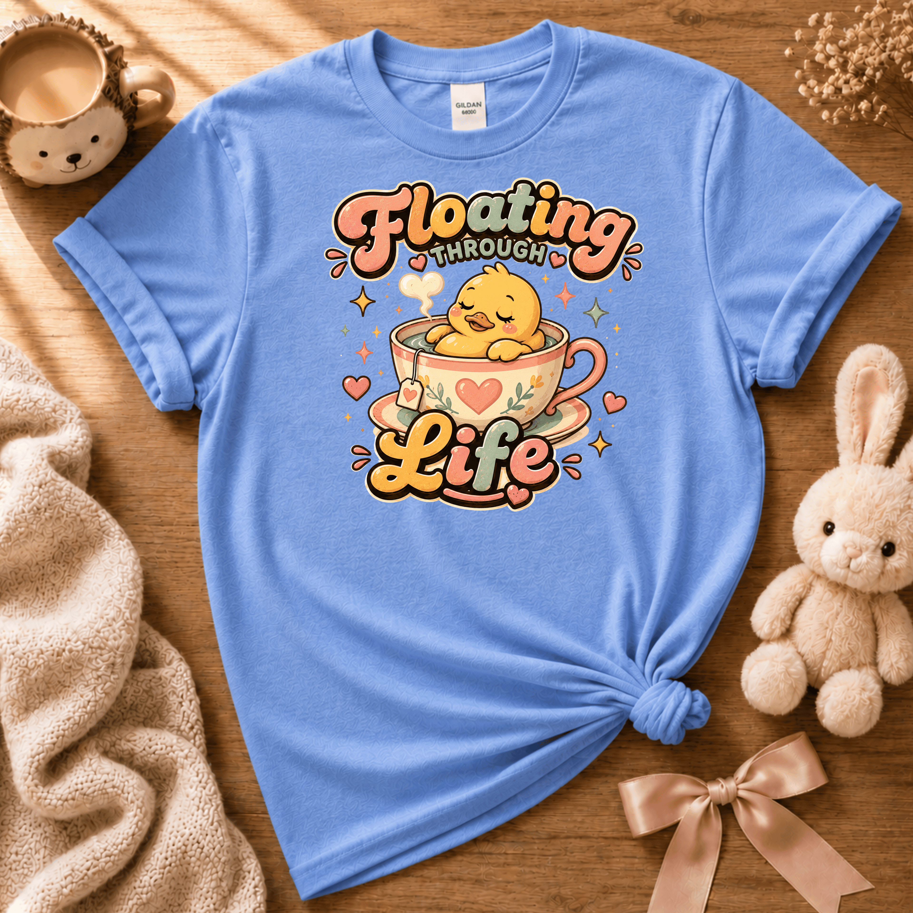 Floating Through Life cute animal graphic t-shirt cozy flat lay in carolina blue.