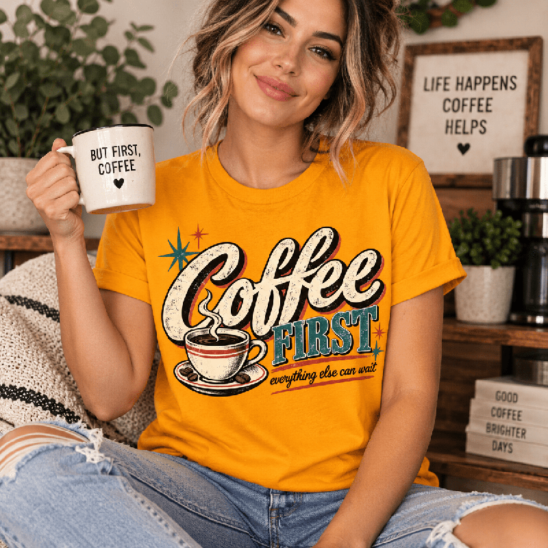 Woman holding a "But First, Coffee" mug, wearing the Coffee First Premium T-Shirt in gold