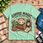 Coffee Magic Premium T-Shirt in mint, flat lay with latte cup, books, moka pot, and "Good Days Start Here" graphic