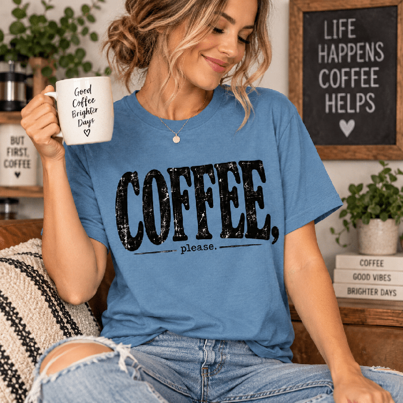 Woman holding a coffee mug, wearing the Coffee Please Premium T-Shirt in steel blue